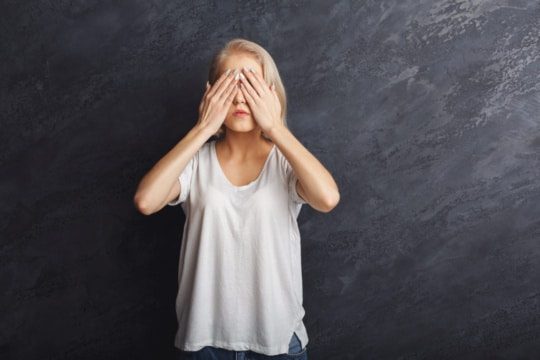 A photo of a woman covering her eyes. encompass solutions erp and business consulting.