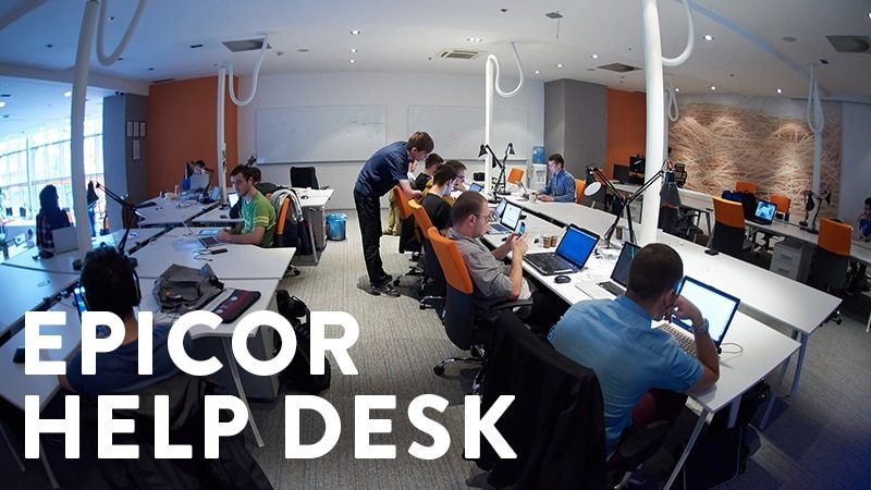 an image of encompass solutions managed services providers at their desks helping Epicor customers.