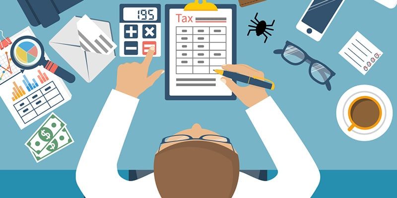 an image of an office worker filling out forms to collect his company's Business Software Tax Deduction.