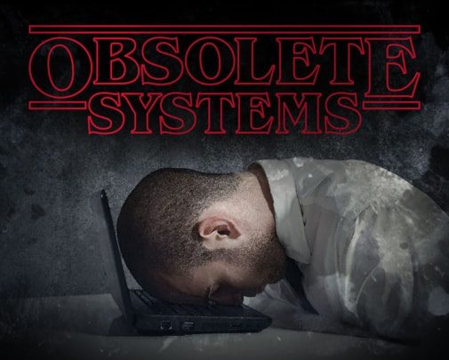 an image of a stressed worker collapsed on his laptop. replacing obsolete systems and conquering the fear of change is essential to the success of your business. encompass solutions erp experts can help.