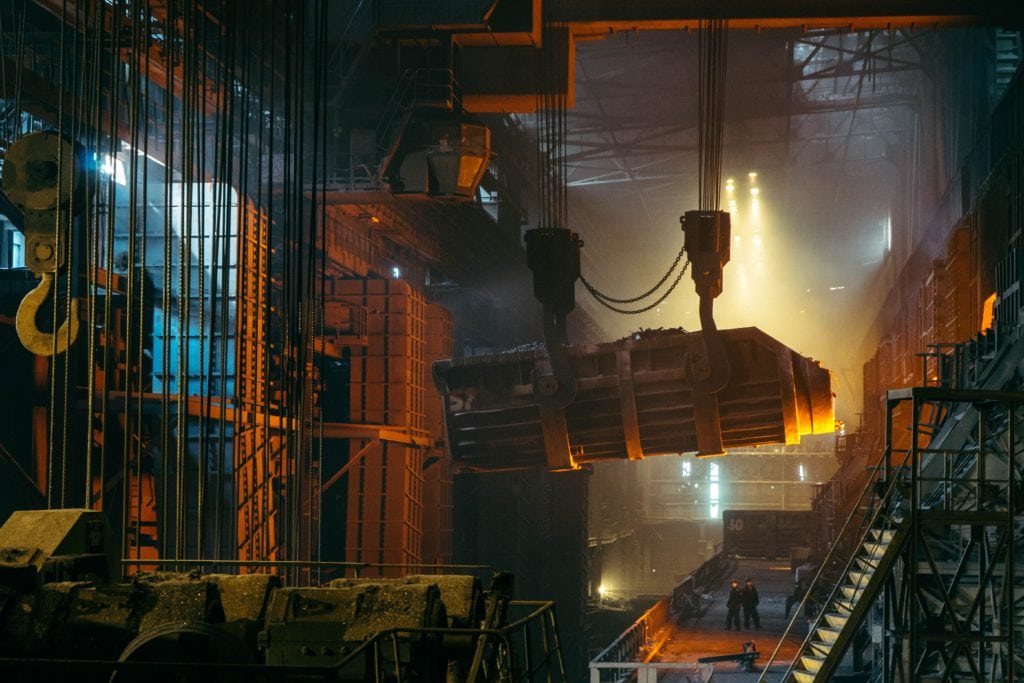 A picture of workers and equipment in a manufacturing facility