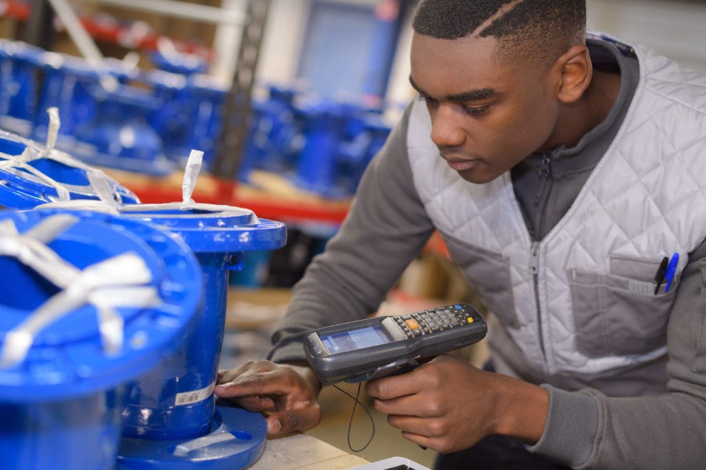 an image of a warehouse worker using a handheld scanner