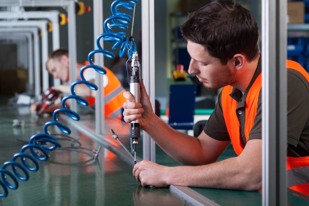 a photograph of factory workers and the production process.