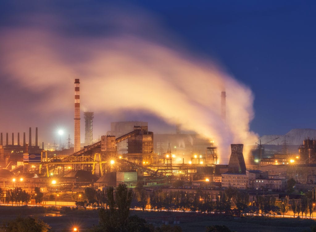 A photo of a metal foundry at night, one of the largest industries affected by US-China Trade. 