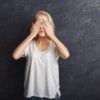 A photo of a woman covering her eyes. encompass solutions erp and business consulting.