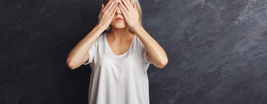 A photo of a woman covering her eyes. encompass solutions erp and business consulting.