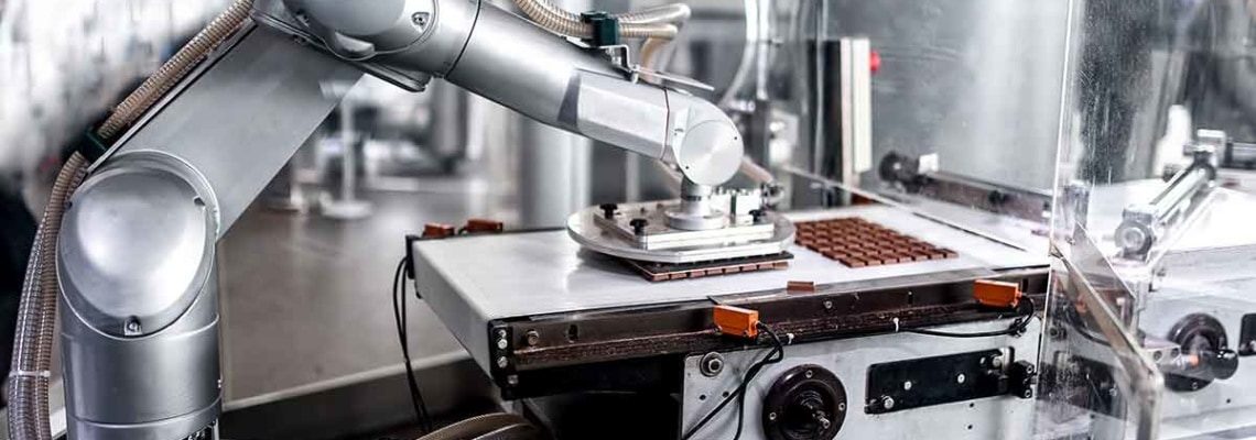 a photo of a robot in a chocolate processing facility