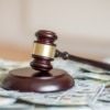 a picture of a gavel on a pile of money as the SCOTUS has ruled on Wayfair vs South Dakota.