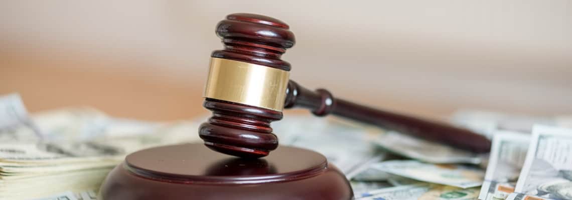 a picture of a gavel on a pile of money as the SCOTUS has ruled on Wayfair vs South Dakota.