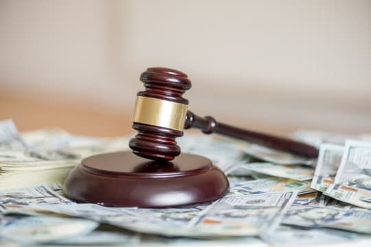 a picture of a gavel on a pile of money as the SCOTUS has ruled on South Dakota v. Wayfair, Inc.