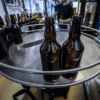 A photograph of bottle being manufactured before labelling and brand personalization