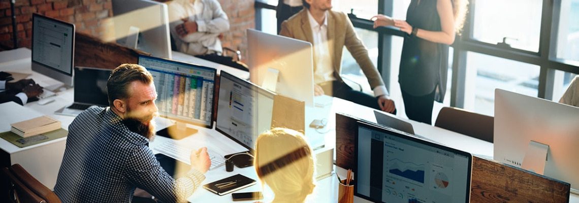 an image of business professionals reviewing eda dashboards and scorecards of business performance