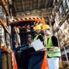 an image of warehouse workers using epicor quick ship on a laptop in the warehouse
