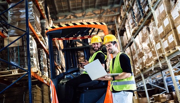 an image of warehouse workers using epicor quick ship on a laptop in the warehouse